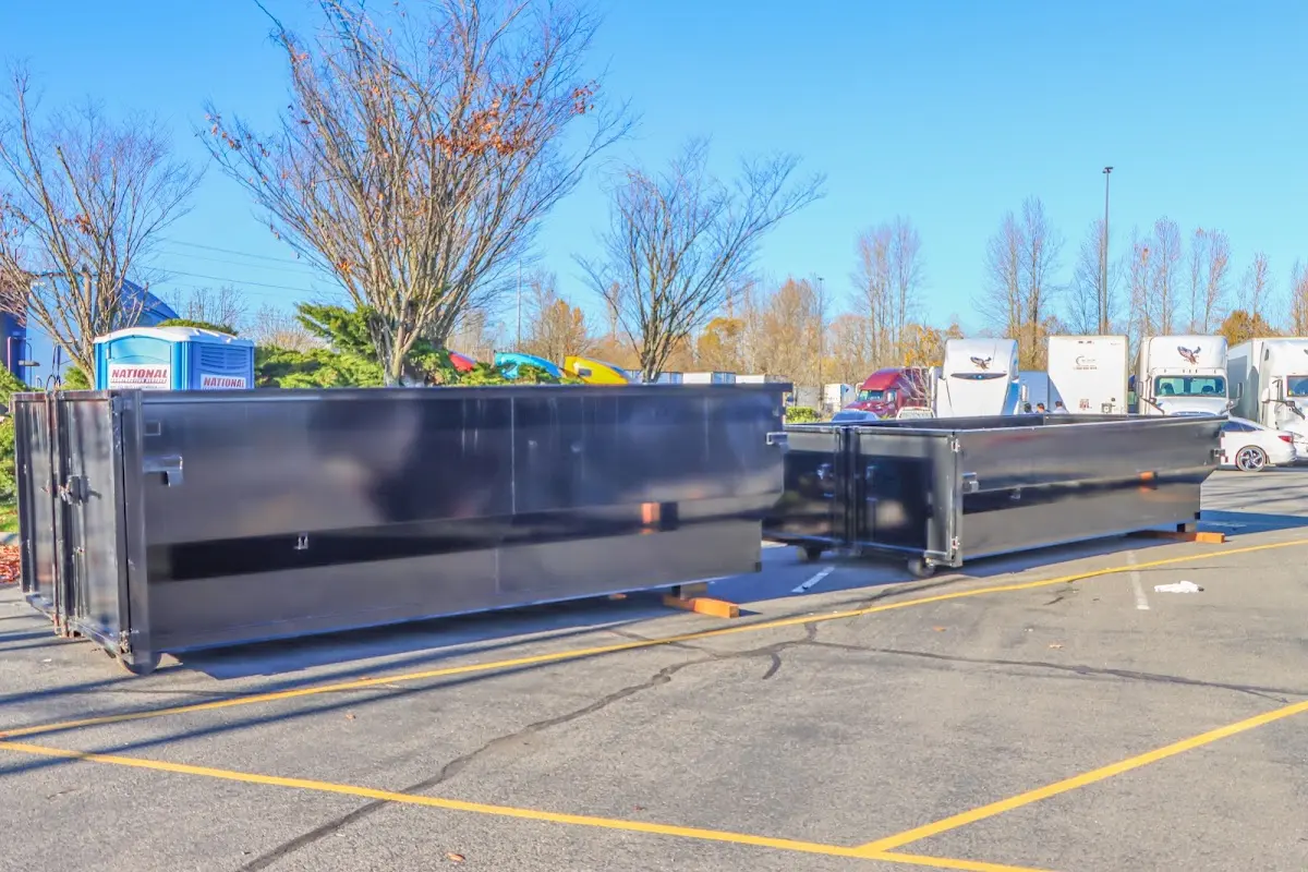 Professional dumpster rental service with roll-off container on residential driveway in Laredo